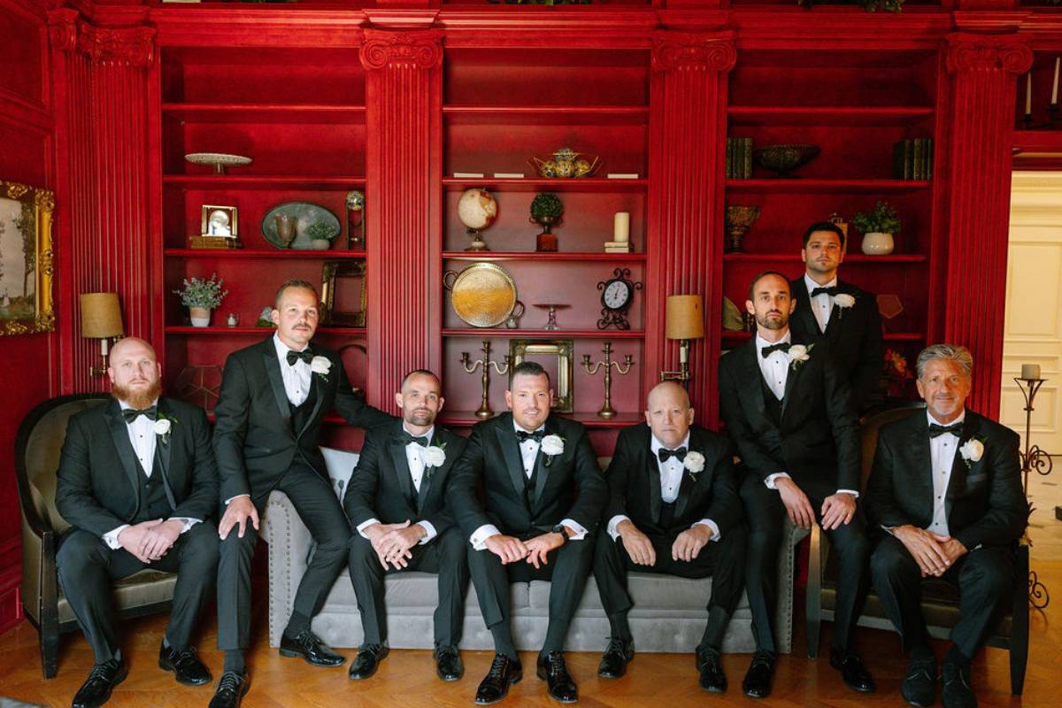 Groom's lounge with rich leather seating and billiards table