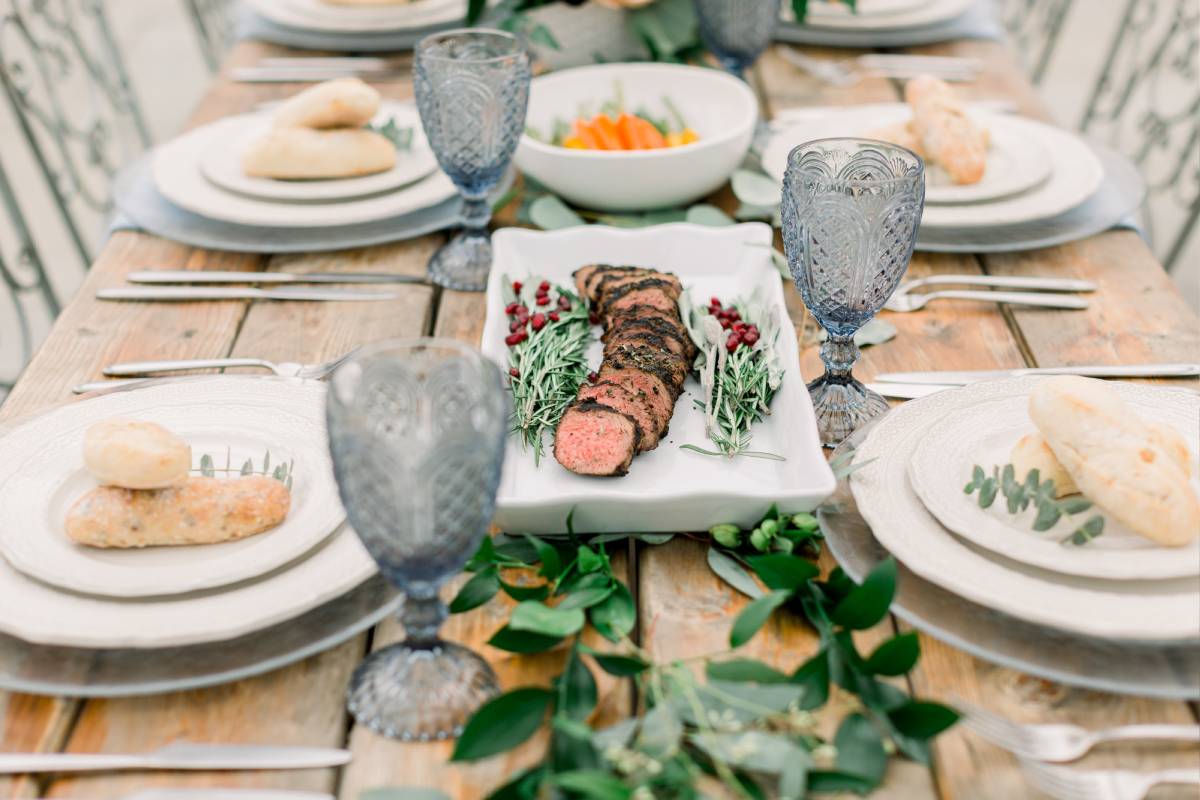 Executive chef plating artisanal wedding dinner dishes in commercial estate kitchen